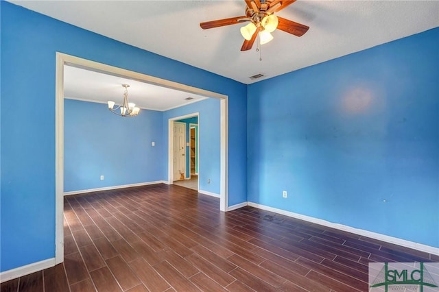 unfurnished room with dark wood-style flooring, baseboards, and ceiling fan with notable chandelier