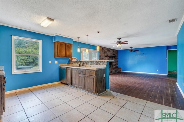 kitchen featuring a peninsula, a textured ceiling, visible vents, dishwasher, and a ceiling fan