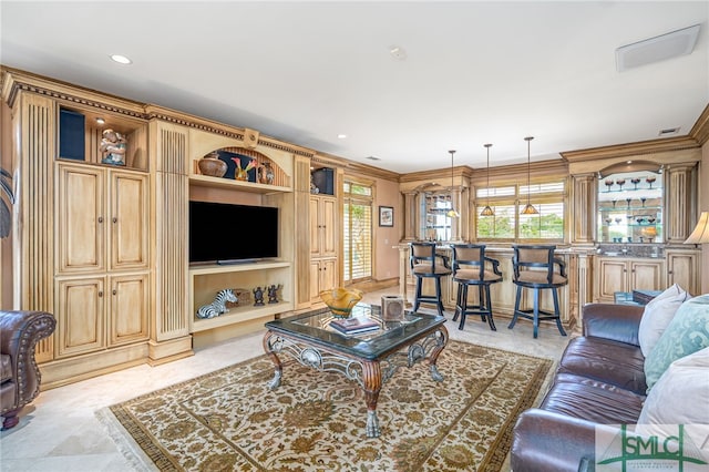 living room featuring visible vents, ornamental molding, and recessed lighting
