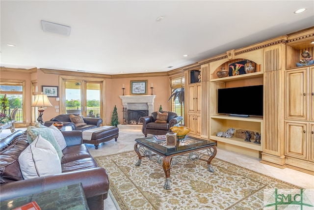 living room featuring crown molding, built in shelves, a fireplace, and recessed lighting