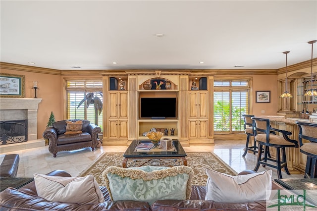 living room featuring crown molding, a high end fireplace, and plenty of natural light
