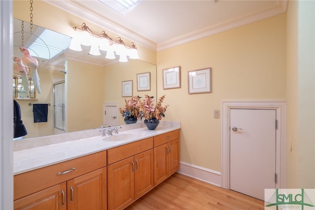 full bathroom featuring baseboards, wood finished floors, vanity, and ornamental molding
