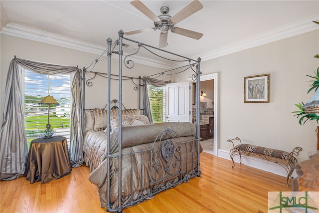 bedroom featuring ensuite bathroom, wood finished floors, ornamental molding, a ceiling fan, and baseboards