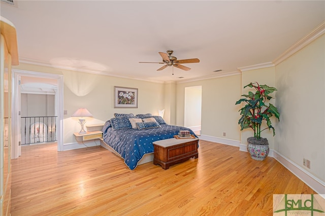 bedroom with ornamental molding, visible vents, ceiling fan, light wood-style flooring, and baseboards