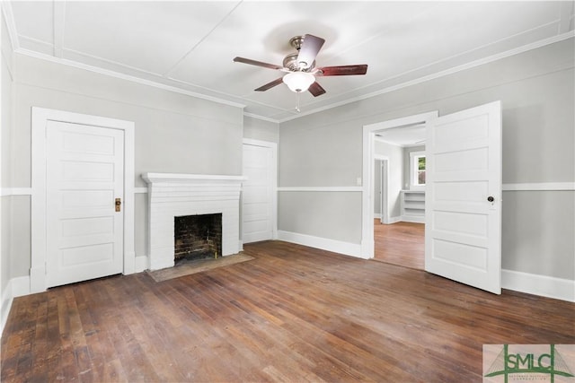 unfurnished living room featuring ornamental molding, a fireplace, wood-type flooring, a ceiling fan, and baseboards