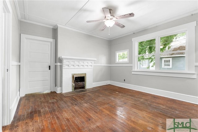 unfurnished living room with ceiling fan, ornamental molding, a fireplace, and hardwood / wood-style floors