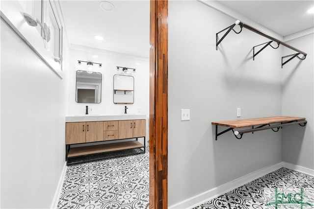 spacious closet featuring light tile patterned floors and a sink