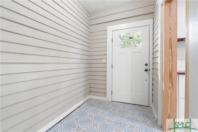 entryway with wooden walls