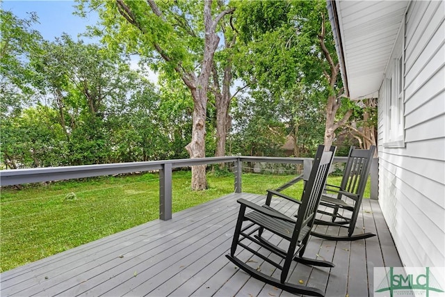 wooden terrace featuring a yard