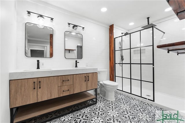 bathroom featuring double vanity, toilet, a shower stall, and a sink