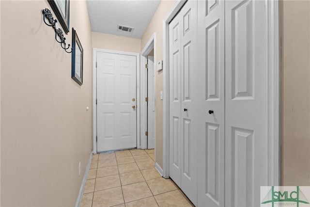 671 M P Martin Rd, Brooklet, GA 30415 - hallway featuring a textured ceiling, baseboards, light tile patterned floors, and visible vents