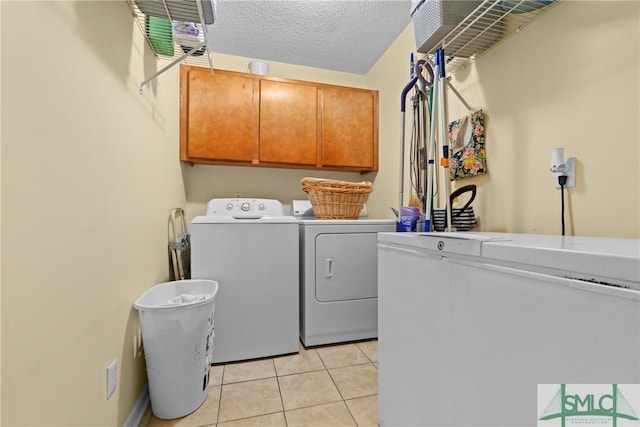 671 M P Martin Rd, Brooklet, GA 30415 - laundry area with separate washer and dryer, a textured ceiling, cabinet space, and light tile patterned floors