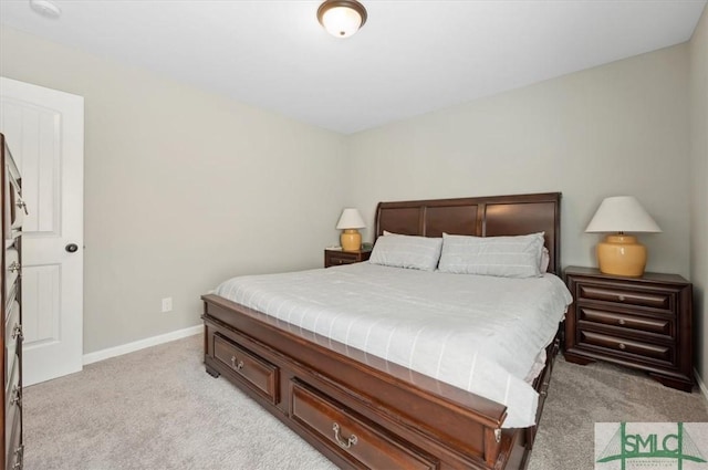 bedroom featuring baseboards and light carpet