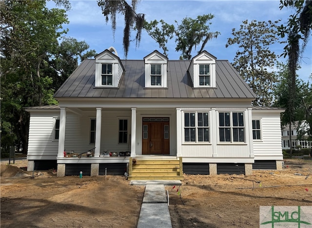 13 Magnolia Ln, Richmond Hill, GA 31324 - new england style home featuring covered porch, metal roof, and a standing seam roof