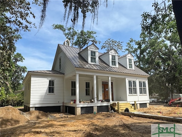 13 Magnolia Ln, Richmond Hill, GA 31324 - new england style home with metal roof, a porch, and a standing seam roof