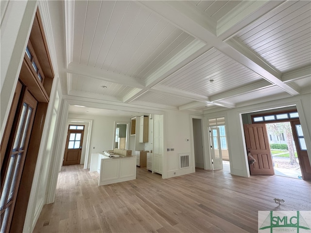 13 Magnolia Ln, Richmond Hill, GA 31324 - unfurnished living room featuring beam ceiling, visible vents, light wood finished floors, coffered ceiling, and baseboards