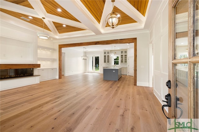 151 Pittman Dr, Rincon, GA 31326 - unfurnished living room with beam ceiling, light wood-type flooring, crown molding, coffered ceiling, and a notable chandelier