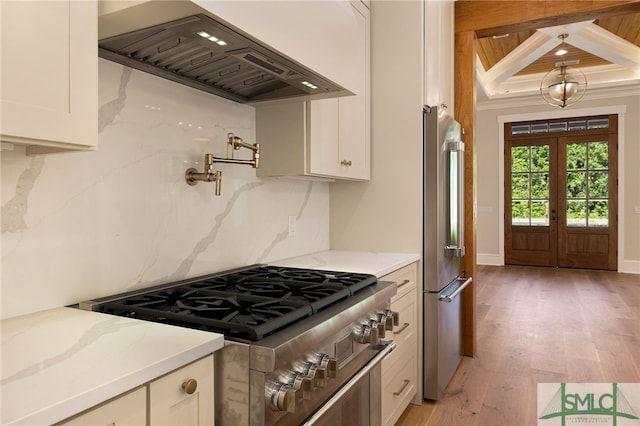 151 Pittman Dr, Rincon, GA 31326 - kitchen featuring light wood-style flooring, coffered ceiling, high quality appliances, white cabinets, and custom range hood