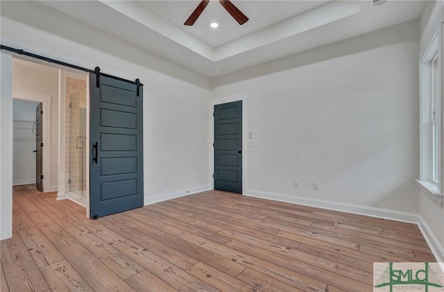 LOT10 Waters Cir, Pembroke, GA 31321 - unfurnished room featuring a barn door, recessed lighting, ceiling fan, light wood-style flooring, and baseboards