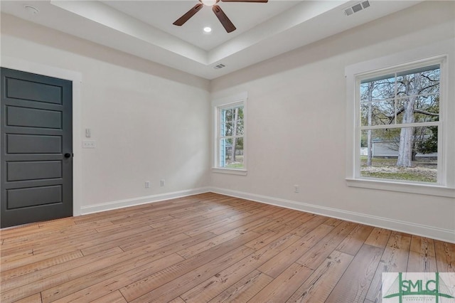 LOT10 Waters Cir, Pembroke, GA 31321 - spare room with a raised ceiling, light wood-style flooring, visible vents, and plenty of natural light