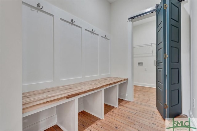LOT10 Waters Cir, Pembroke, GA 31321 - mudroom with light wood-type flooring, baseboards, and a barn door