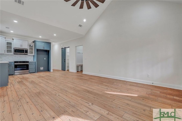 LOT10 Waters Cir, Pembroke, GA 31321 - unfurnished living room featuring a ceiling fan, recessed lighting, a barn door, high vaulted ceiling, and light wood-type flooring