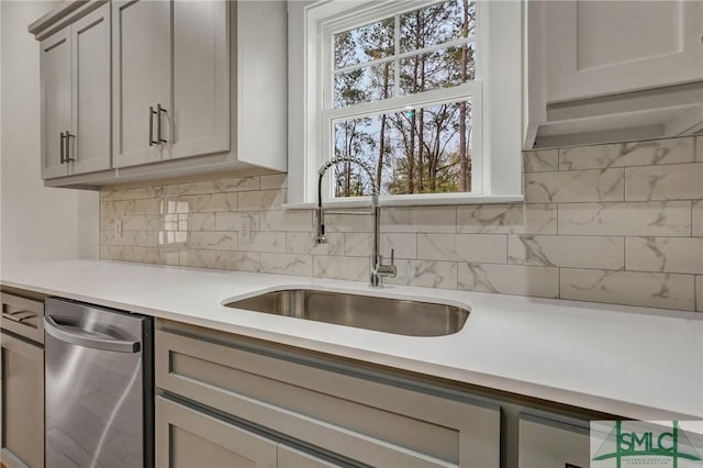 LOT10 Waters Cir, Pembroke, GA 31321 - kitchen with stainless steel dishwasher, light countertops, decorative backsplash, and a sink