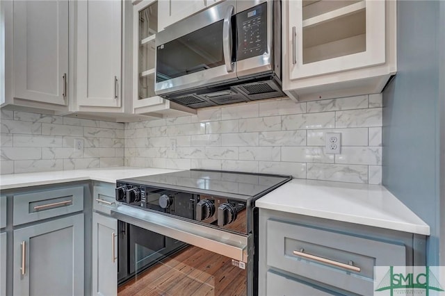 LOT10 Waters Cir, Pembroke, GA 31321 - kitchen with glass insert cabinets, light countertops, electric range oven, and stainless steel microwave