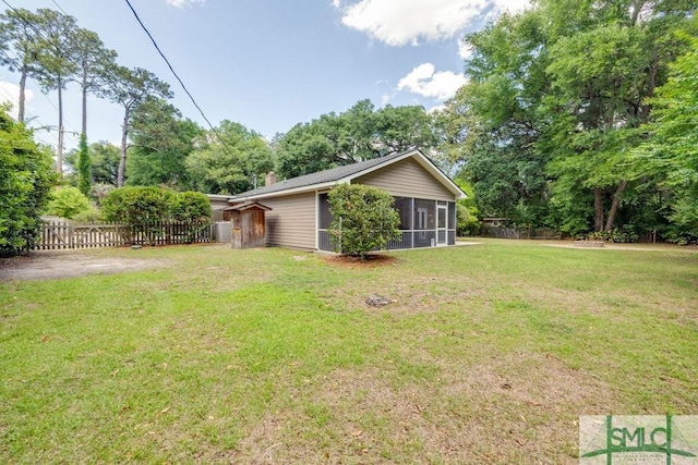 view of yard with a sunroom and fence