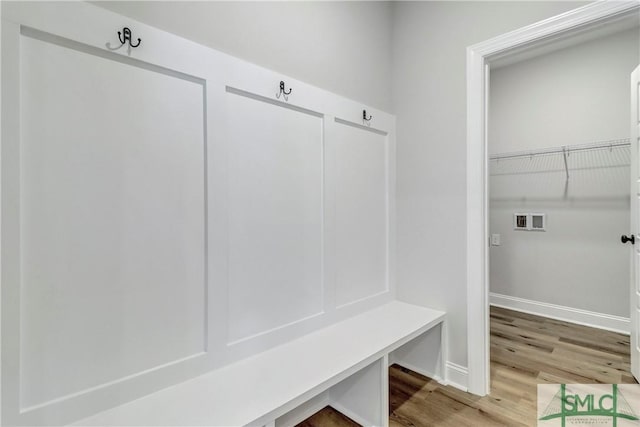 mudroom featuring baseboards and light wood-type flooring