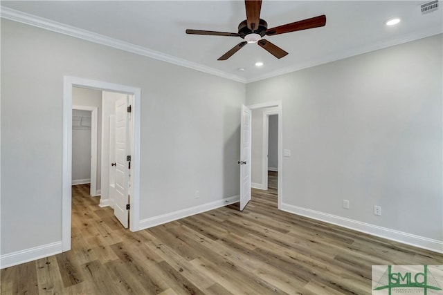 unfurnished bedroom featuring wood finished floors, ornamental molding, visible vents, recessed lighting, and baseboards