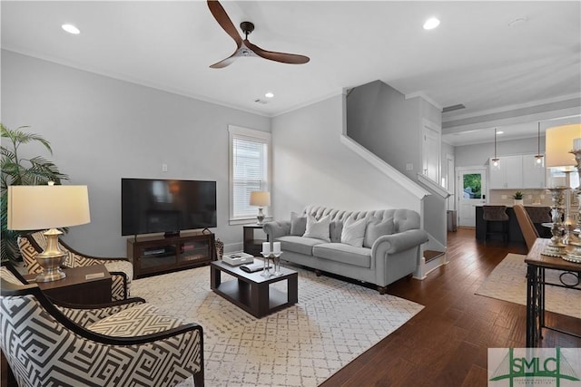 living room featuring recessed lighting, a wealth of natural light, a ceiling fan, and dark wood finished floors