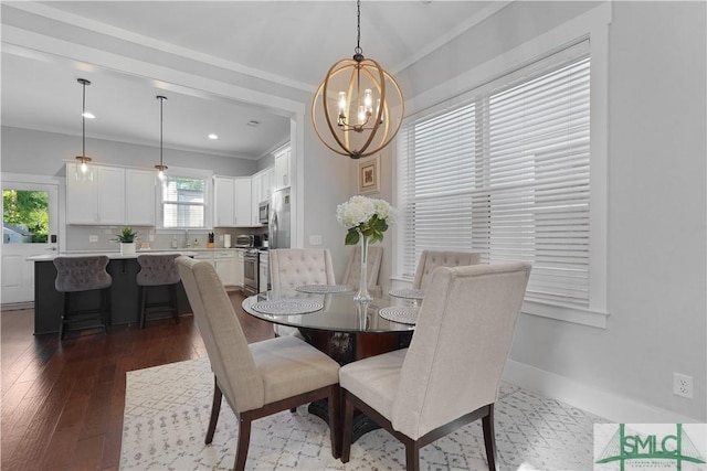 dining space with crown molding, a chandelier, baseboards, and dark wood-style floors