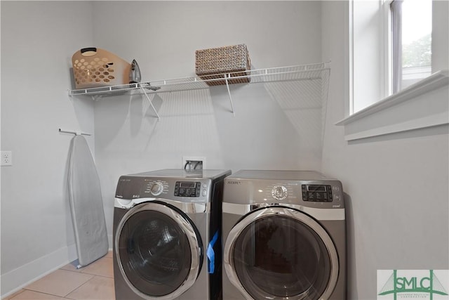washroom featuring baseboards, tile patterned flooring, laundry area, and independent washer and dryer