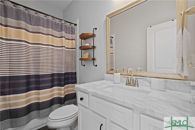 bathroom with toilet, vanity, and a shower with shower curtain