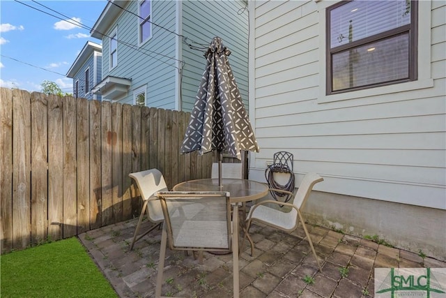 view of patio / terrace with outdoor dining area and fence