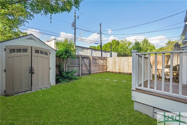 view of yard featuring a storage shed, an outdoor structure, and a fenced backyard