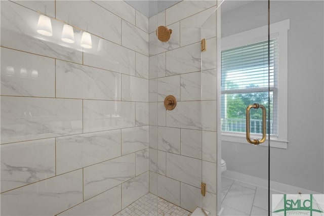 bathroom featuring a shower stall, marble finish floor, baseboards, and toilet