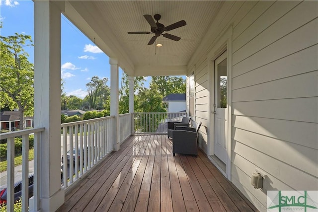 wooden terrace featuring ceiling fan