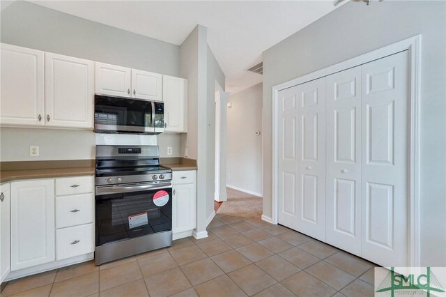 104 Coach House Sq, Pooler, GA 31322 - kitchen with light tile patterned floors, baseboards, visible vents, stainless steel appliances, and white cabinets