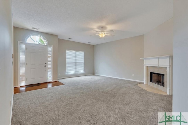 104 Coach House Sq, Pooler, GA 31322 - unfurnished living room with a ceiling fan, baseboards, visible vents, a tile fireplace, and carpet floors