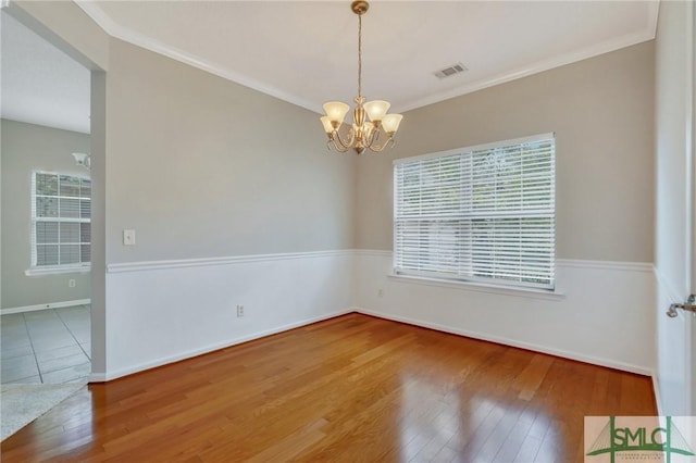 104 Coach House Sq, Pooler, GA 31322 - spare room featuring hardwood / wood-style floors, crown molding, a chandelier, and visible vents
