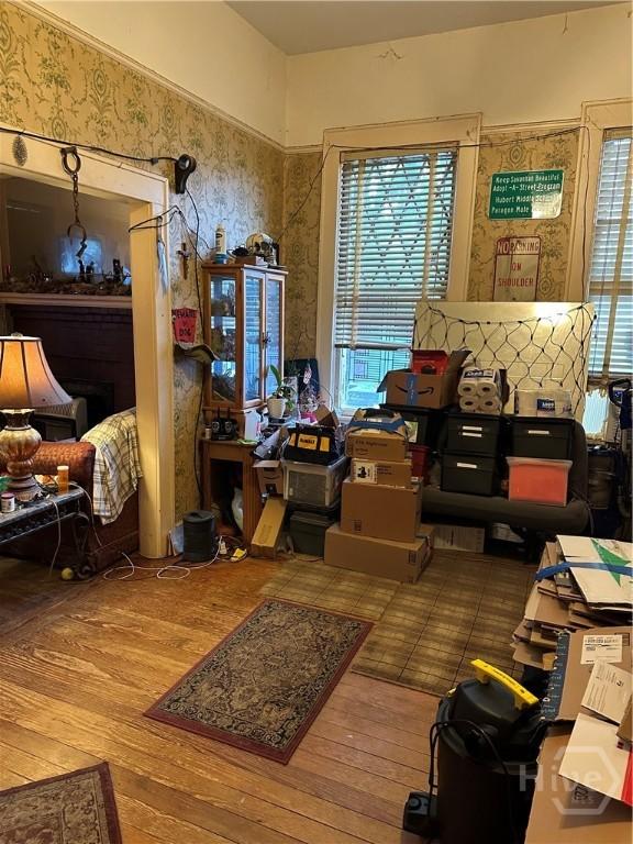 misc room featuring plenty of natural light, hardwood / wood-style flooring, and wallpapered walls