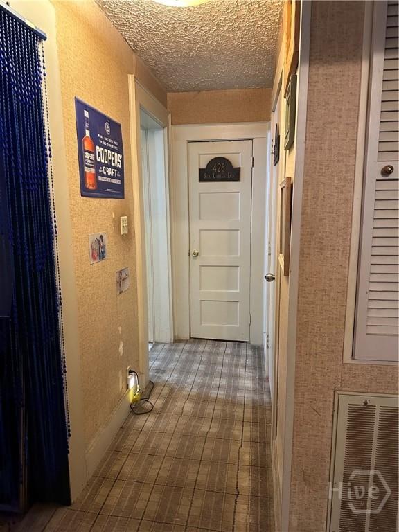hallway featuring a textured ceiling
