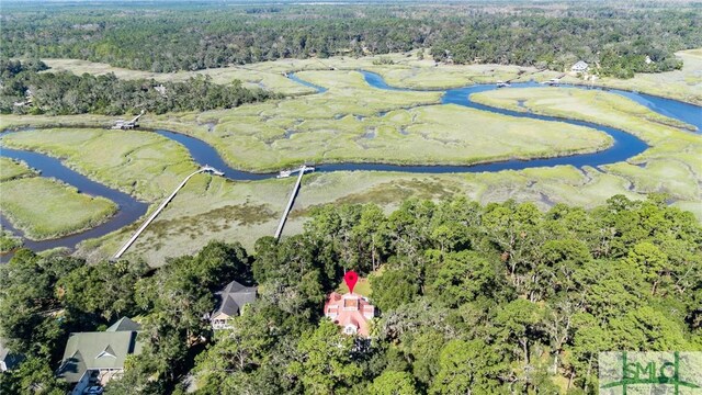 bird's eye view featuring a wooded view and a water view