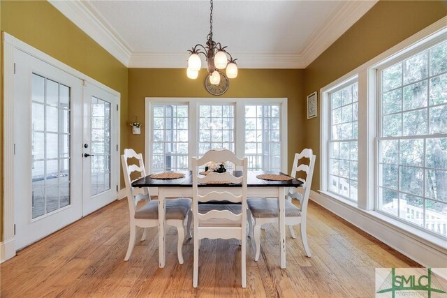 dining room featuring an inviting chandelier, a healthy amount of sunlight, and light wood-style floors