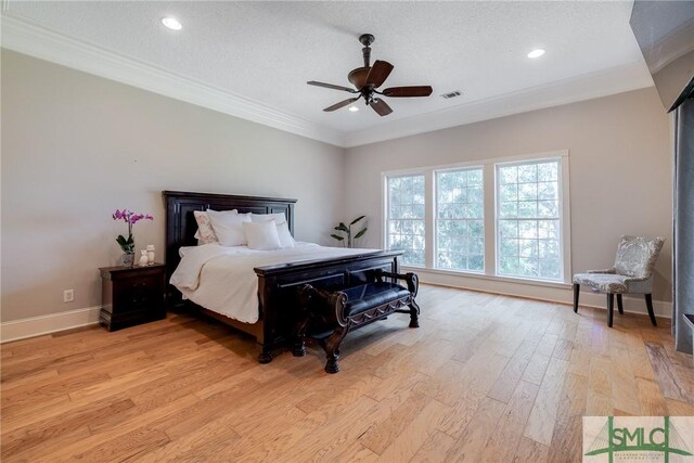bedroom with crown molding, light wood-type flooring, visible vents, and recessed lighting