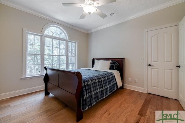 bedroom with ornamental molding, baseboards, a ceiling fan, and light wood-style floors