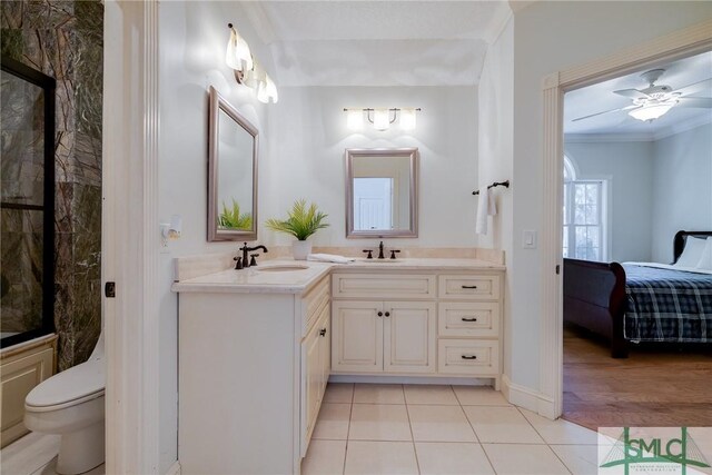 ensuite bathroom with a sink, double vanity, connected bathroom, and tile patterned floors