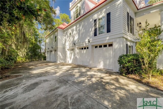 view of side of property with an attached garage and driveway